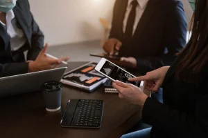 business-documents-office-table-with-smart-phone-calculator-digital-tablet-graph-business-with-social-network-diagram-two-colleagues-discussing-data-working-office 1